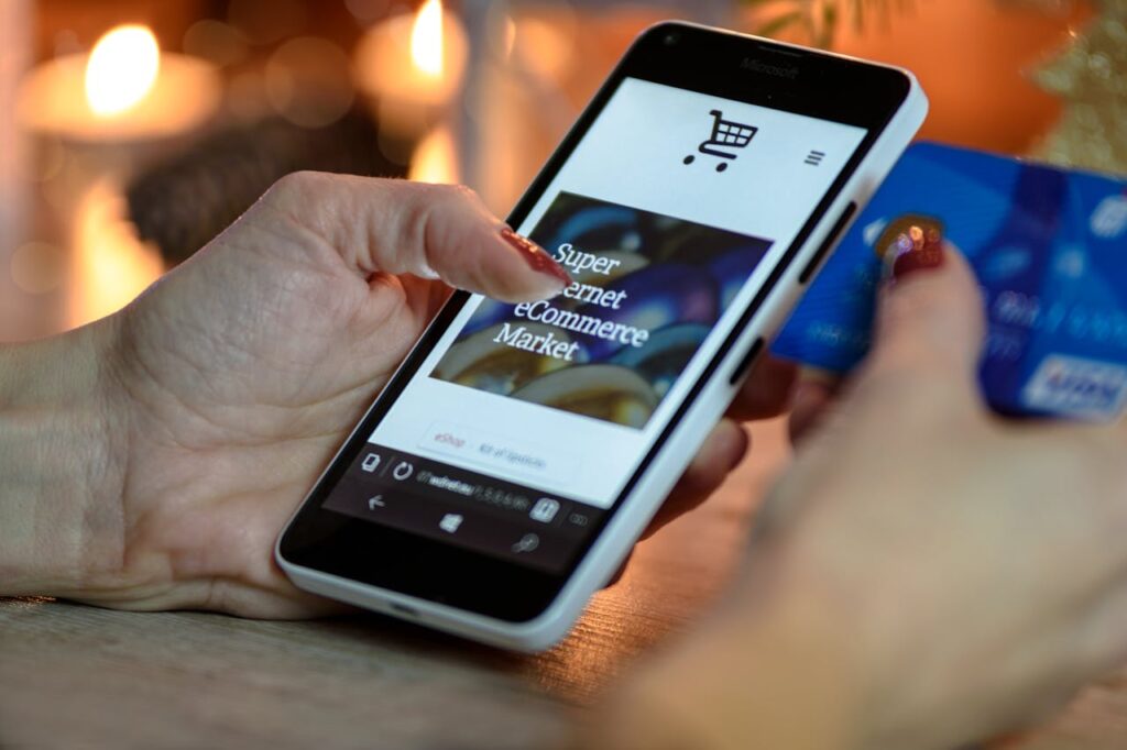 person-using-black-and-white-smartphone-and-holding-blue-card-230544 Person Using Black And White Smartphone and Holding Blue Card